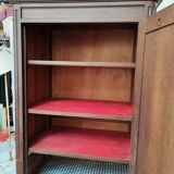 Bonnetière man standing cabinet a door