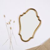 Old wooden mirror gilded with gold leaf