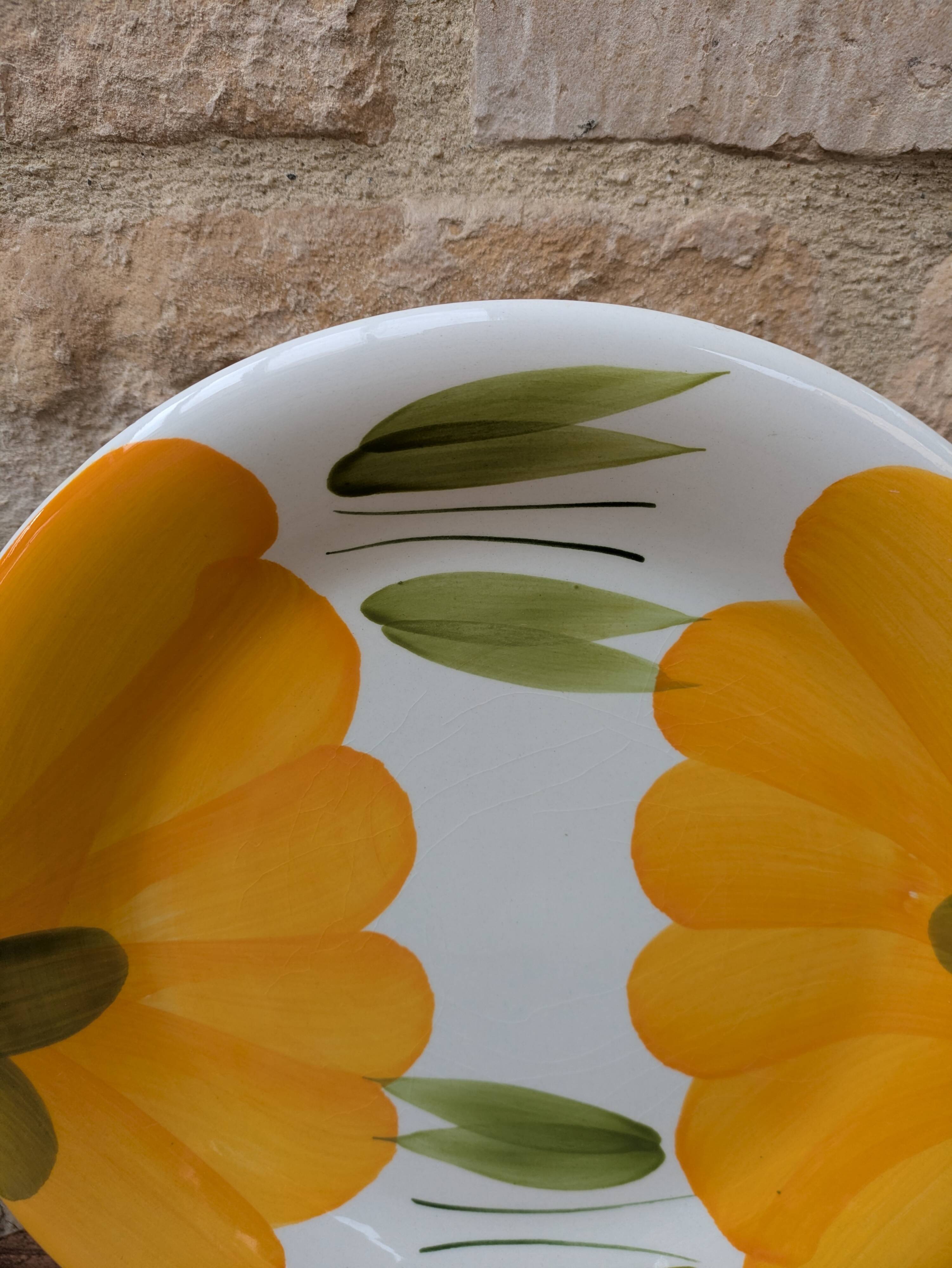 Round serving dish with hand-painted yellow flowers in ceramic TC Italy.