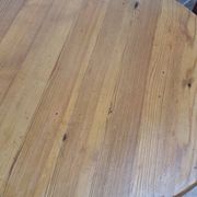Scandinavian coffee table in solid pine with tripod legs in Swedish chalet style.