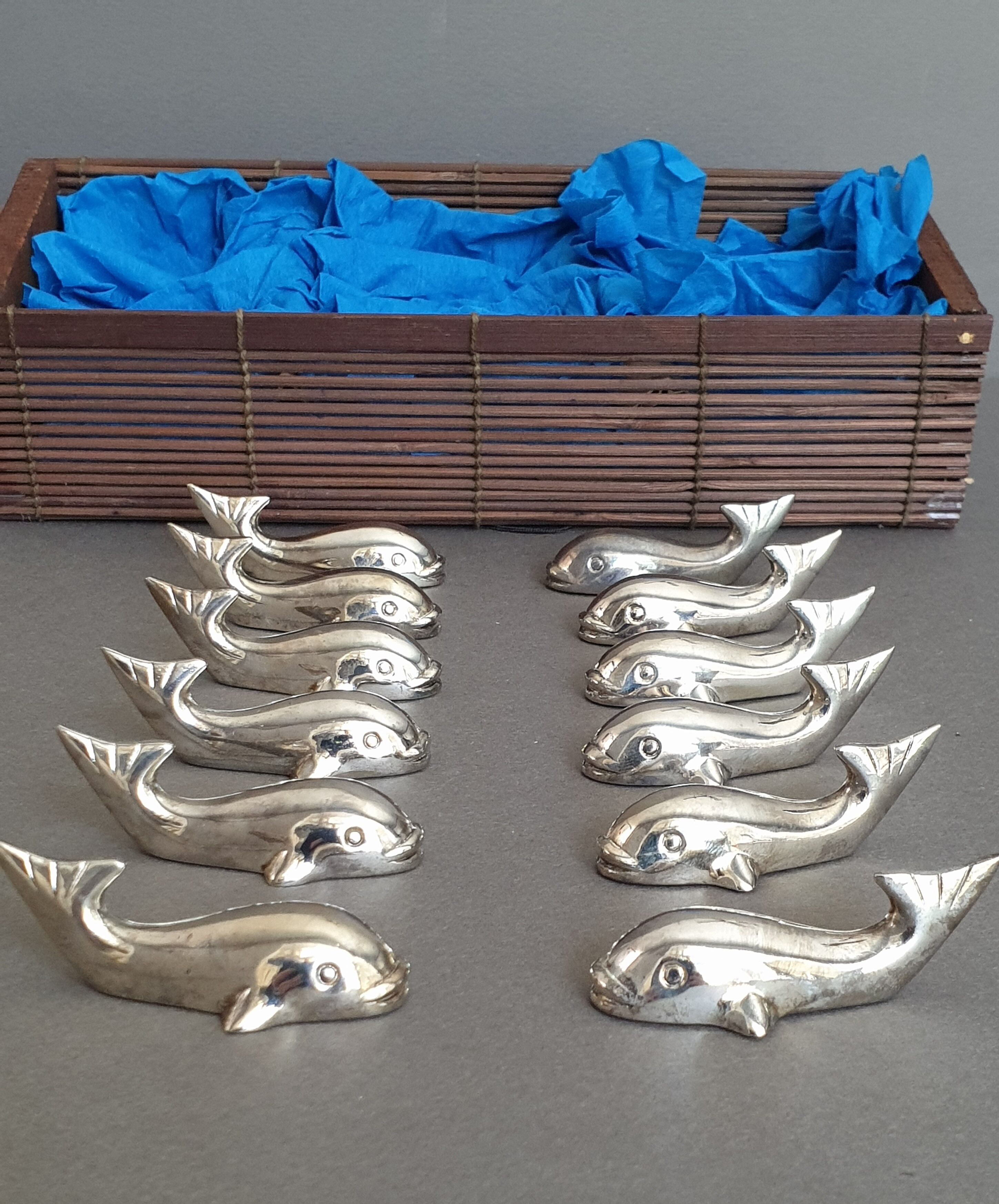 Lot 12 knife holders in the shape of a stylized whale or fish
