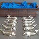 Lot 12 knife holders in the shape of a stylized whale or fish