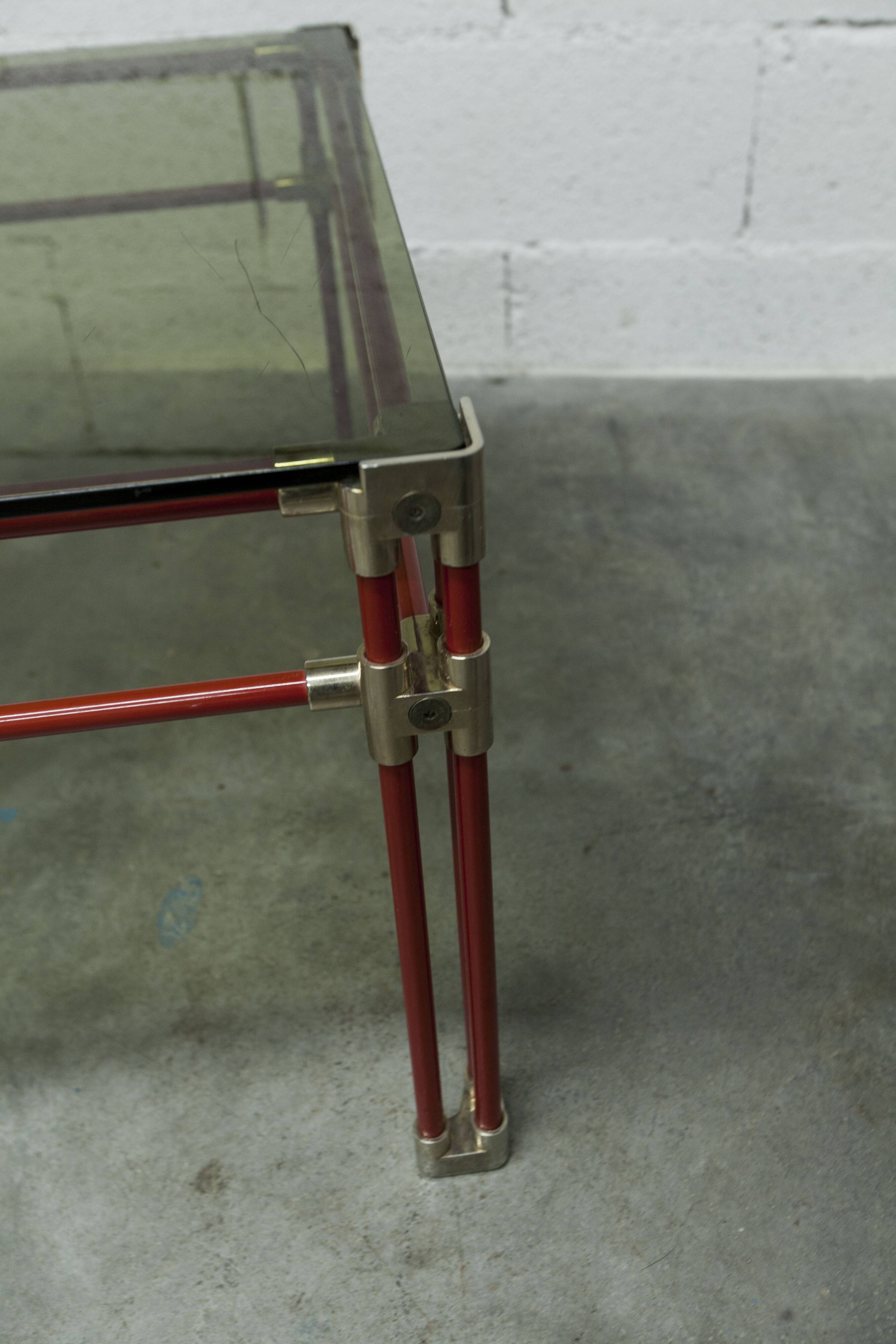 Postmodern Italian design coffee table in smoked glass with red steel structure