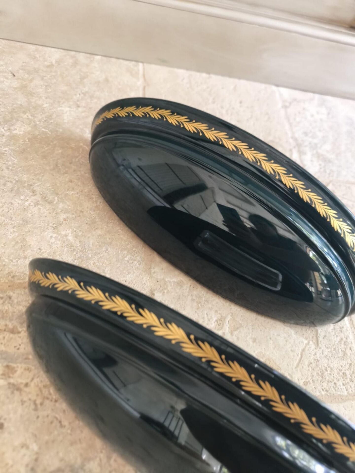 Set of two vintage wall sconces in pine green and gold.