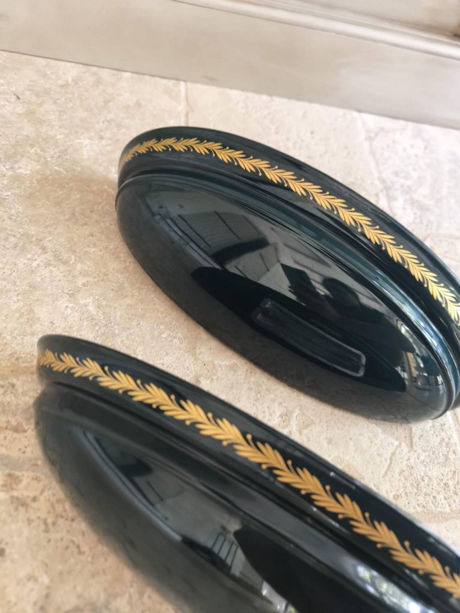 Set of two vintage wall sconces in pine green and gold.