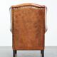 Wingback chair made of sheep leather with black piping in good condition