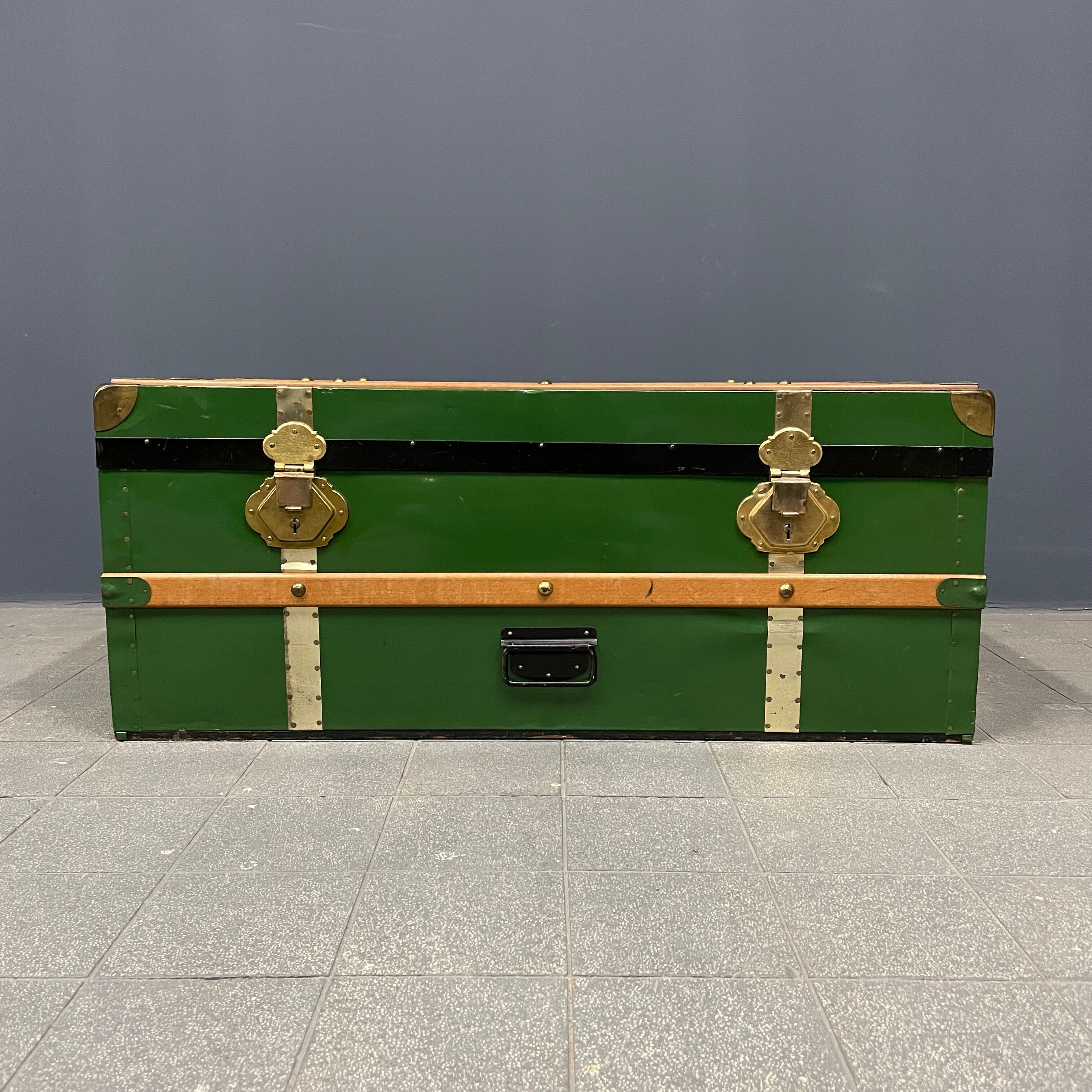 Green metal trunk with wooden sleds