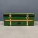 Green metal trunk with wooden sleds