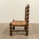 Low chair in beaded wood and straw