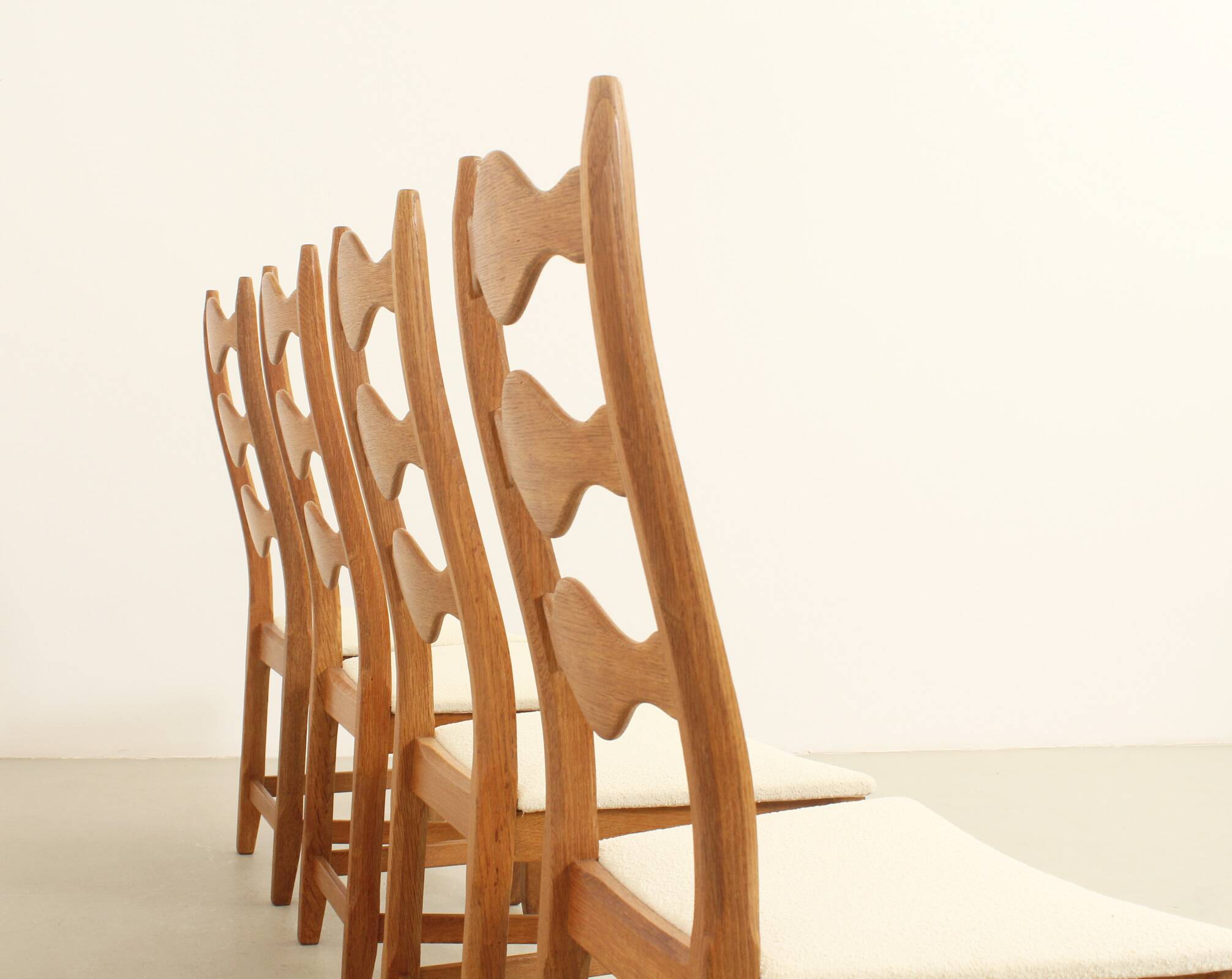 Four oak dining chairs by Henning Kjaernulf.