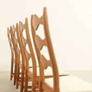 Four oak dining chairs by Henning Kjaernulf.
