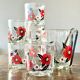 The service of 6 whiskey glasses with red flowers, with its bucket and its ice cube tongs.
