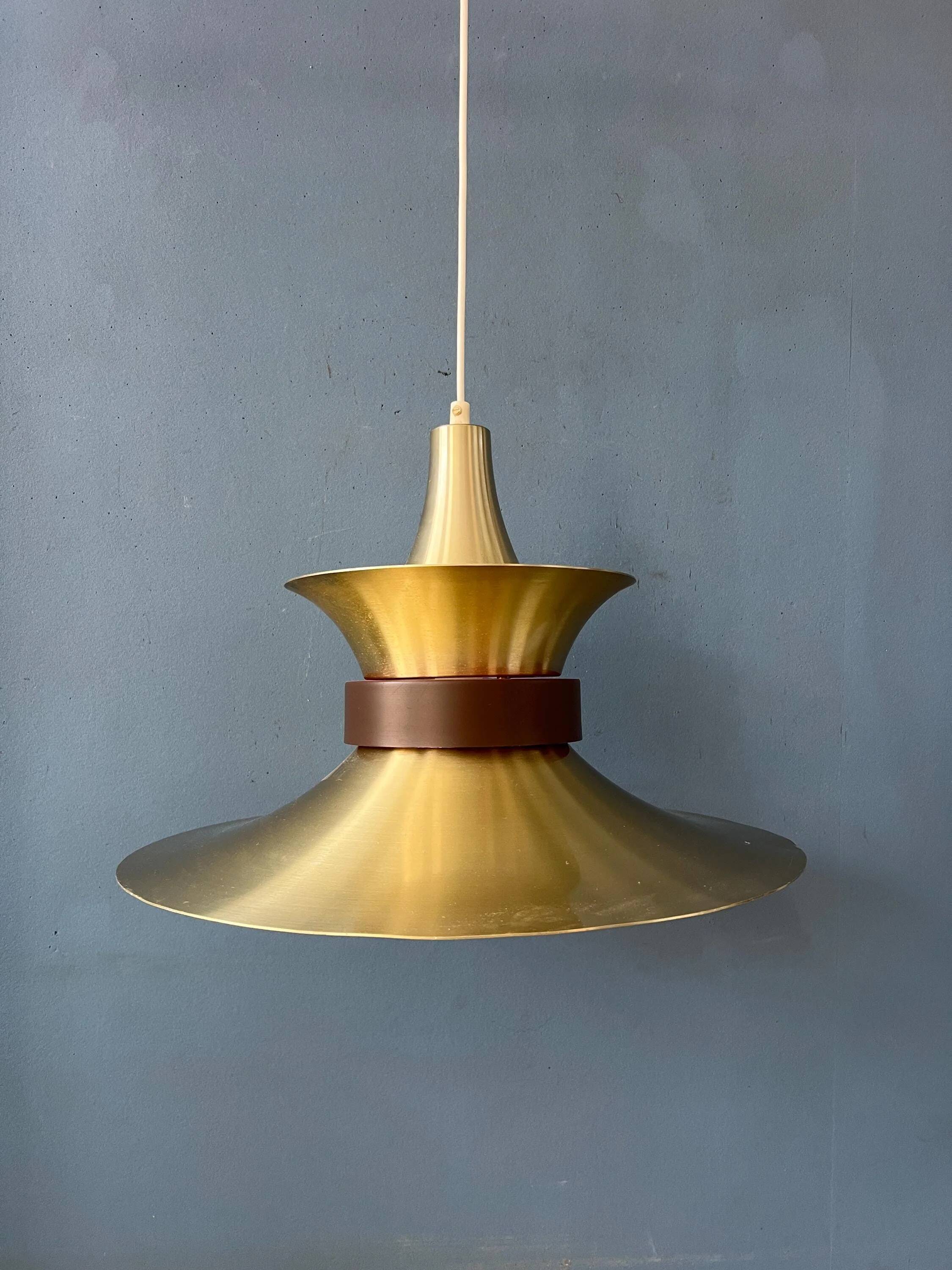 Large UFO flying saucer pendant light with orange light.