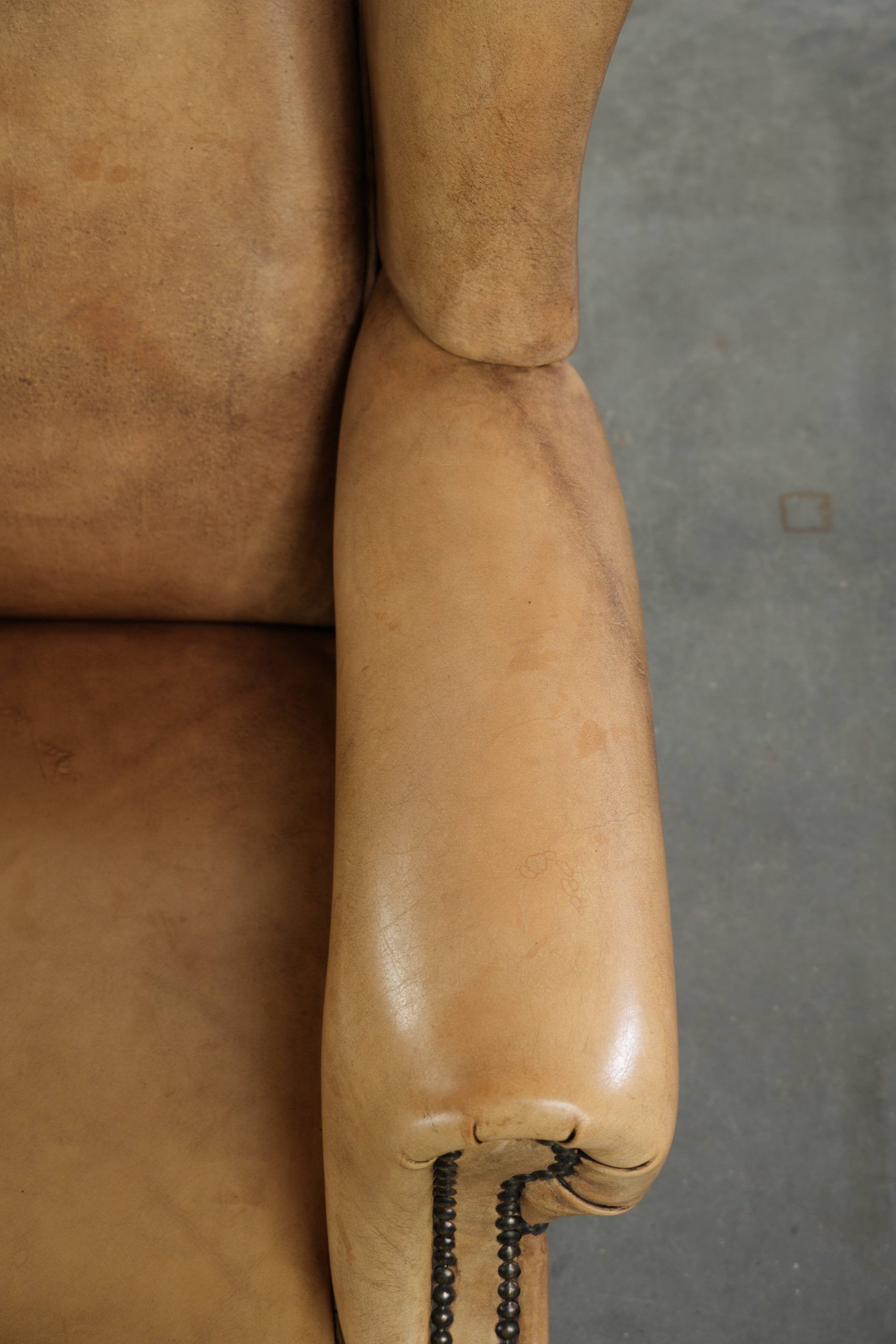 Comfortable cowhide wingback armchair with a timeless English look