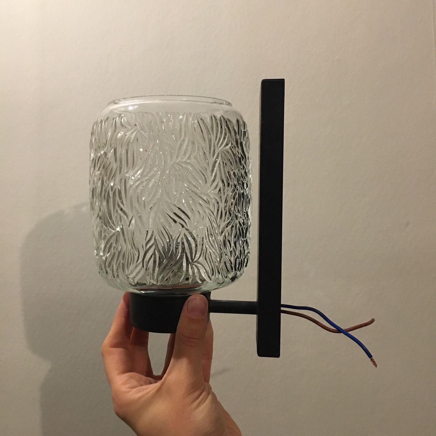 Black metal and molded glass wall sconce