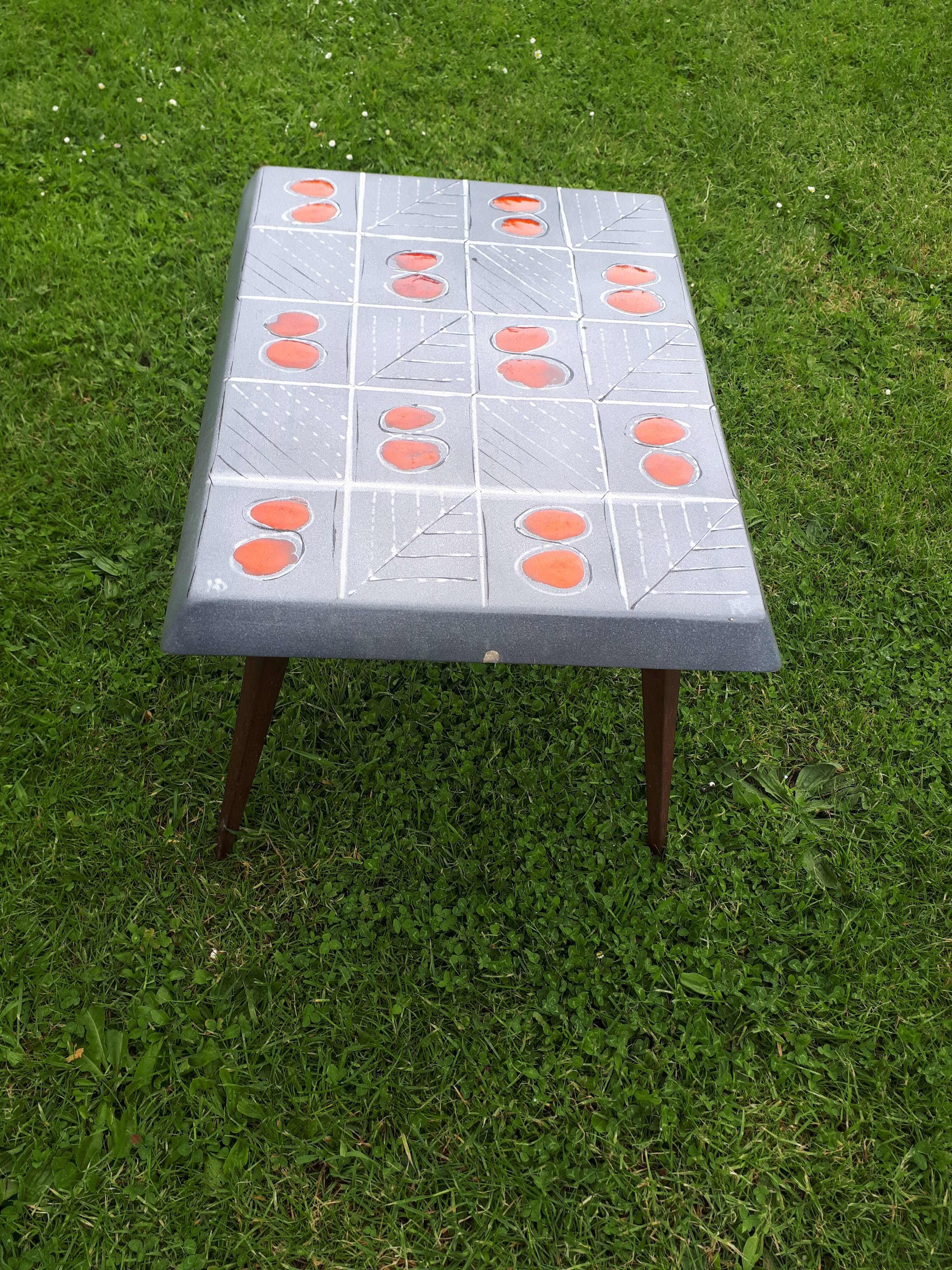 Small 1960s enamelled table, spindle legs, signed jd.