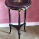 Tripod stool in blackened wood with painted floral decoration.
