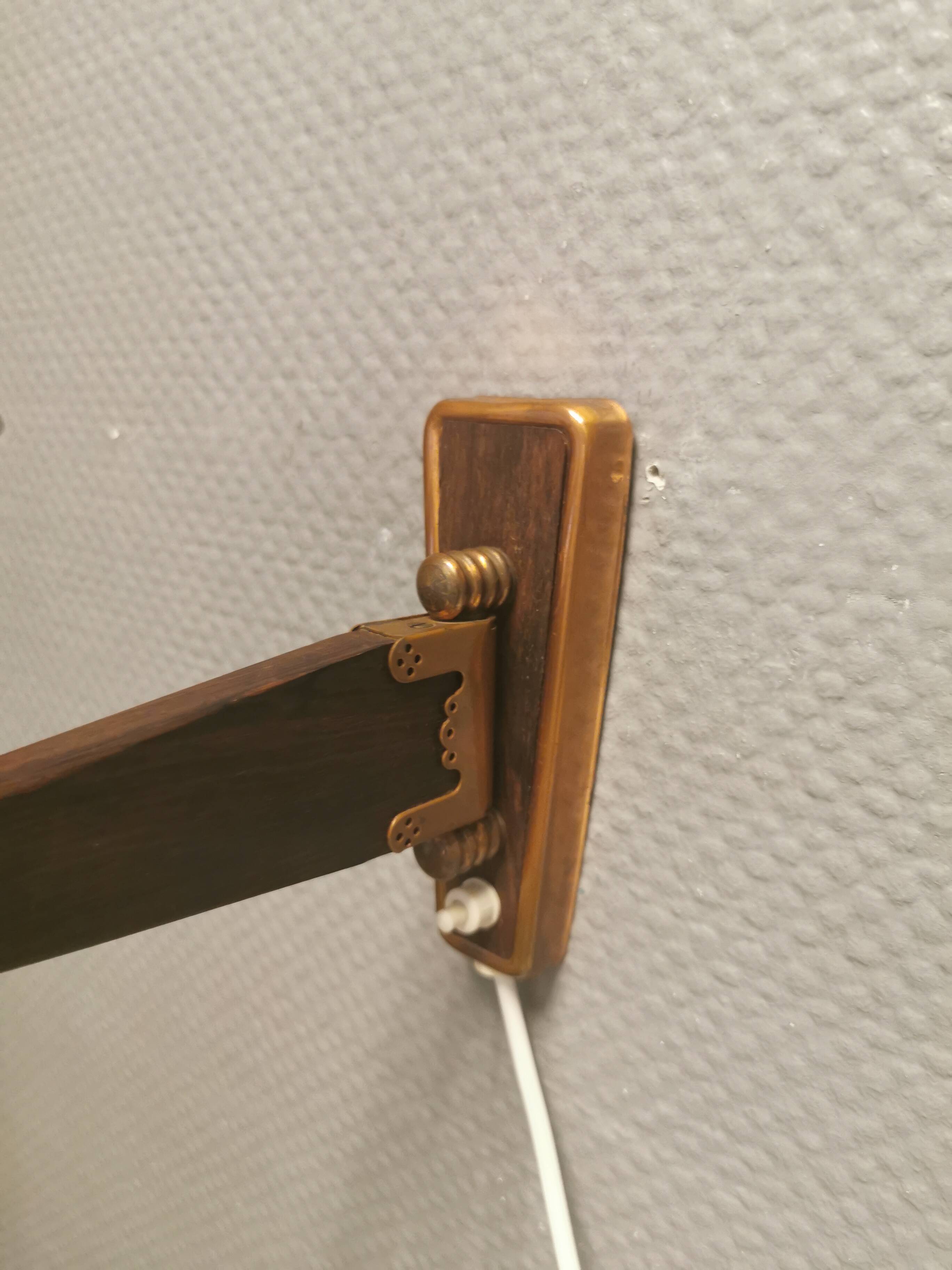 Wall lamp with adjustable ‘arm’ in copper and rosewood, with white shade.