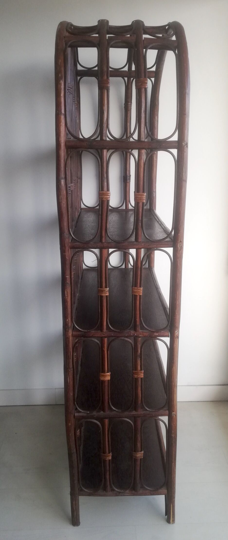 Library shelves in dark rattan