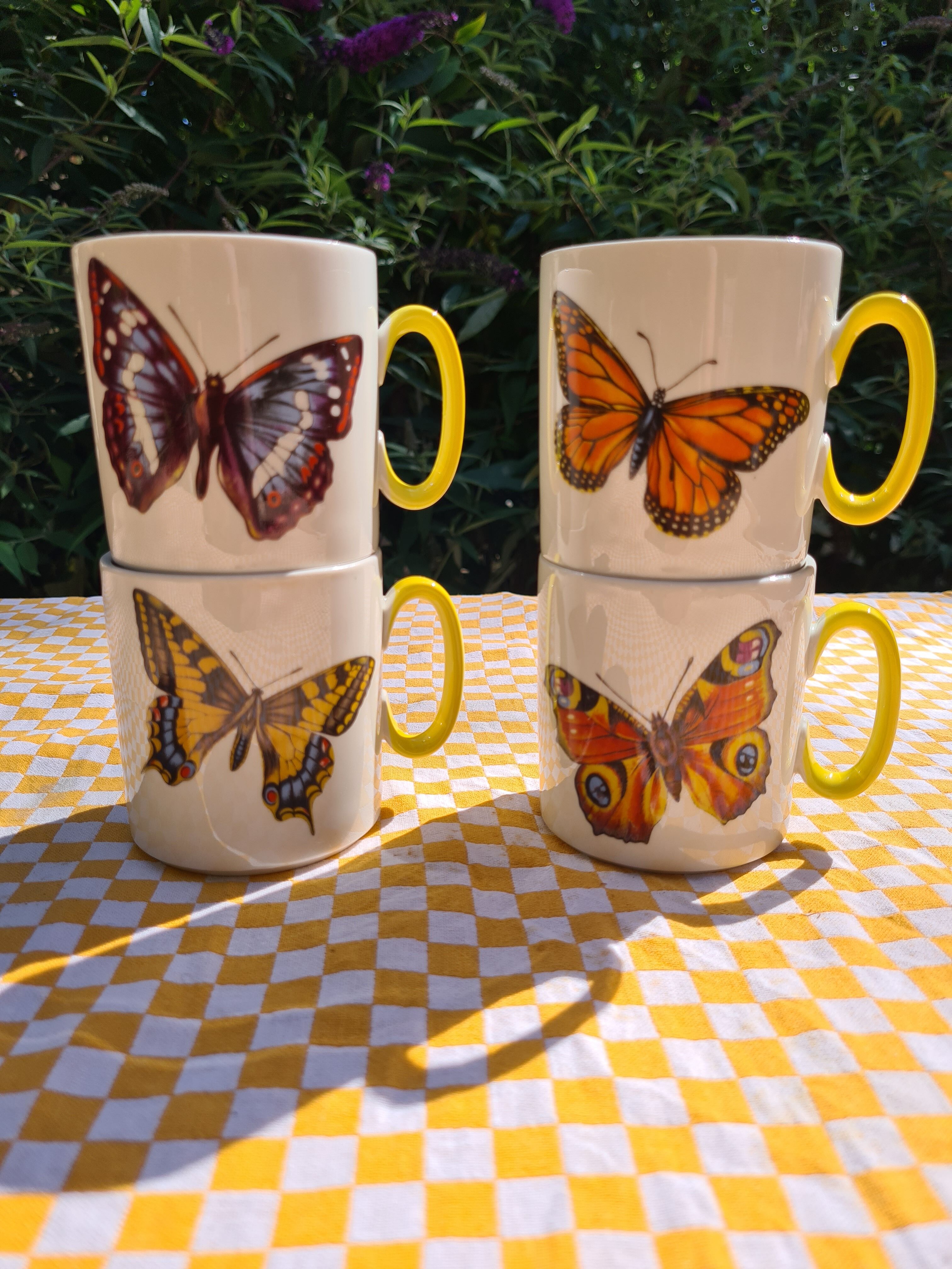 Four mugs decorated with Villeroy and Boch butterflies