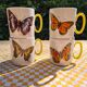 Four mugs decorated with Villeroy and Boch butterflies