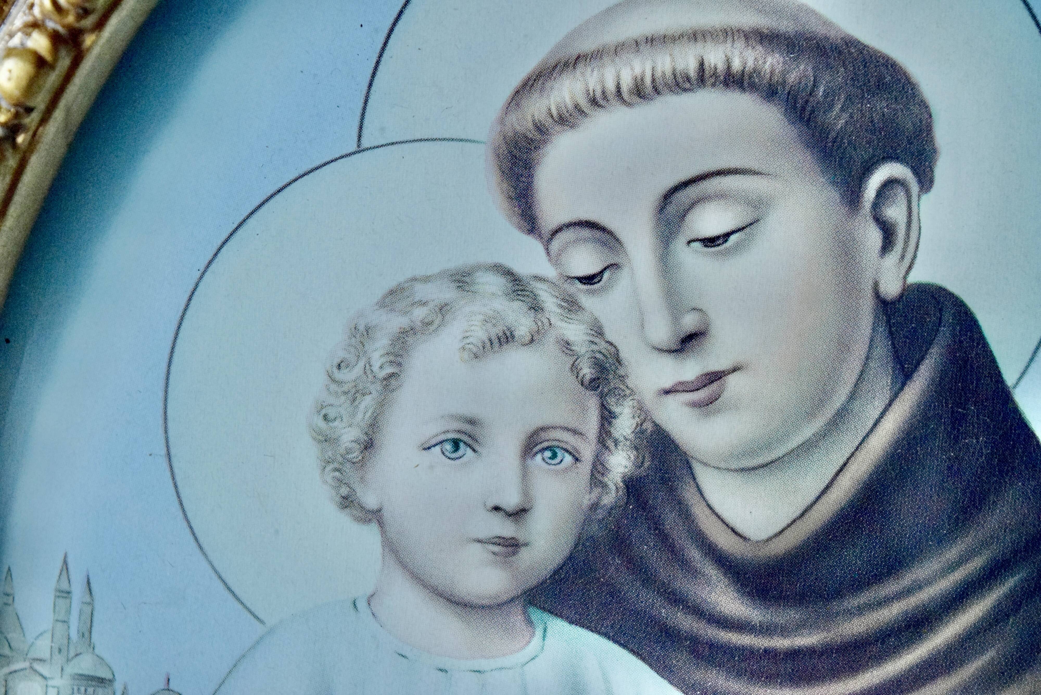 Old religious light frame in gilded stucco and curved glass