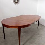 Round teak table with Scandinavian design extensions from the 60s vintage