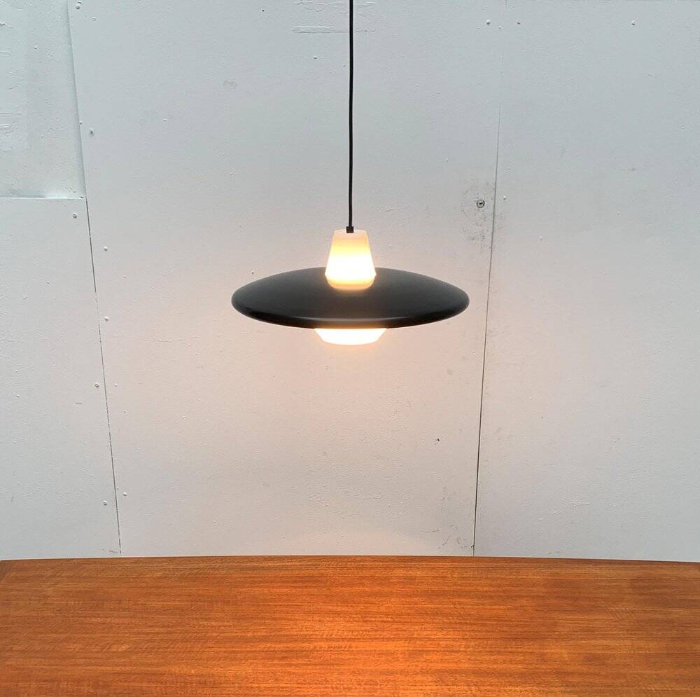 Minimalist metal and glass pendant lamp in mid-century style.