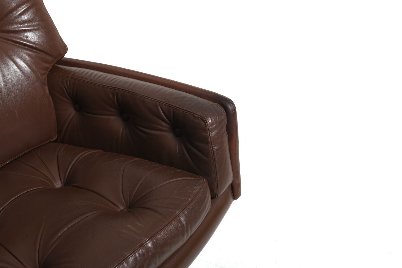 Danish swivel lounge chair in brown leather