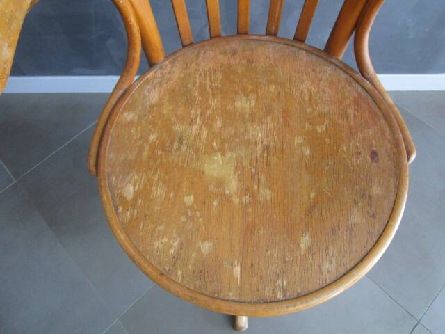 Old swivel office armchair in curved wood