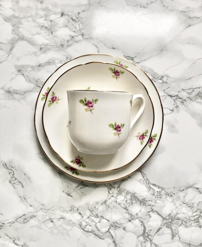 Teacup on its saucer and porcelain cake plate