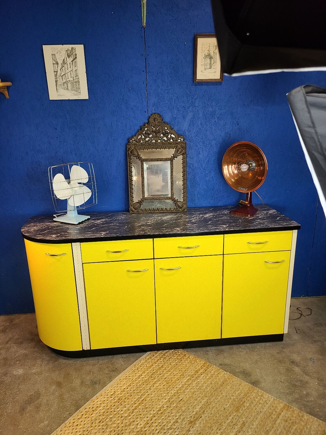 Vintage yellow sideboard, and black marble top.
