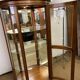 Wooden display case and half-moon mirror