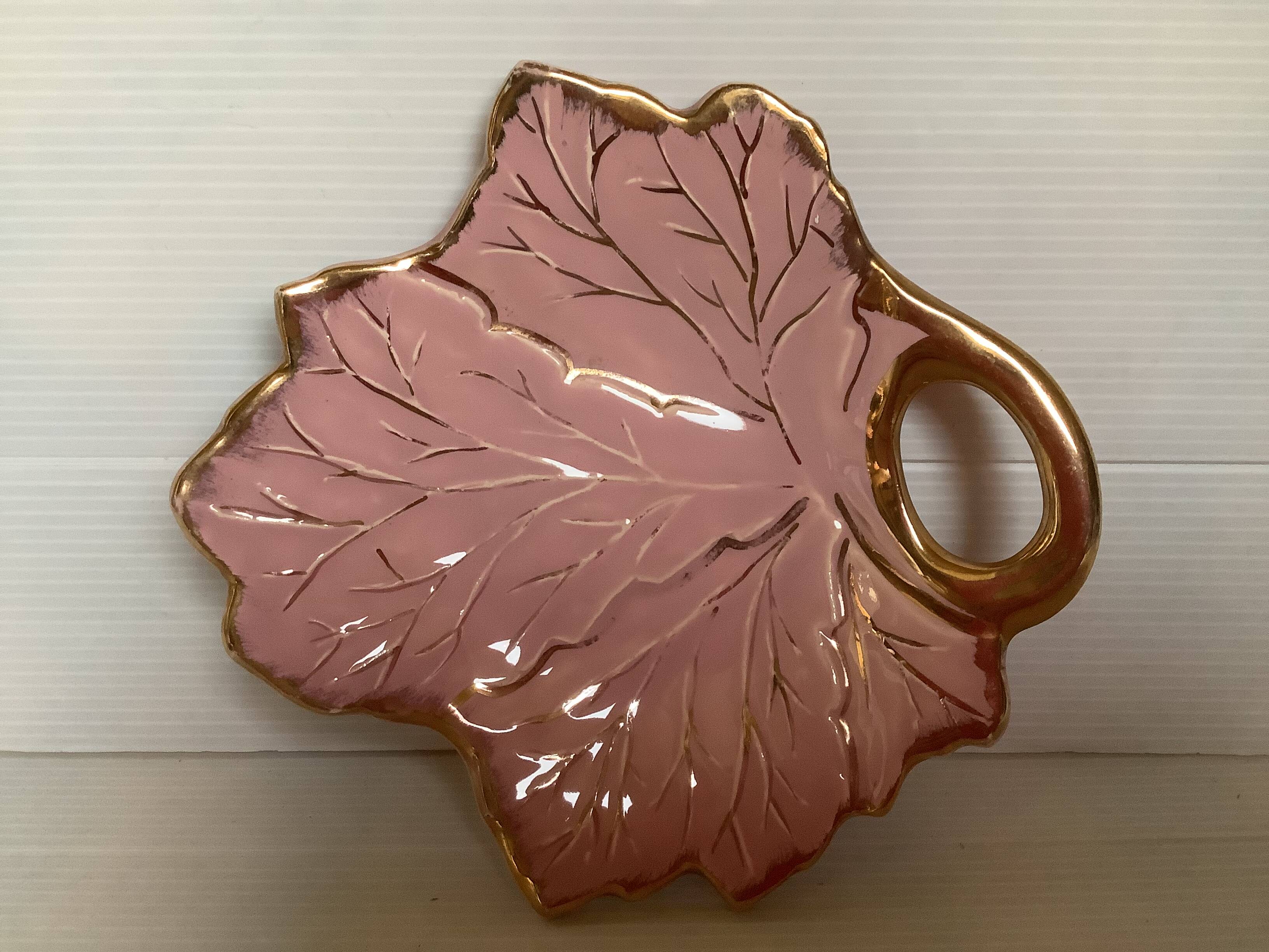 Tray, ring holder in the shape of a pink and gold leaf.