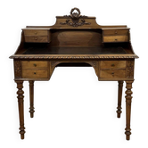 Louis XVI style desk from the late 19th century in walnut with a leather top.