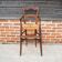 Old wooden high chair for children with straw.