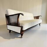 Vintage wooden armchair with rattan weaving.