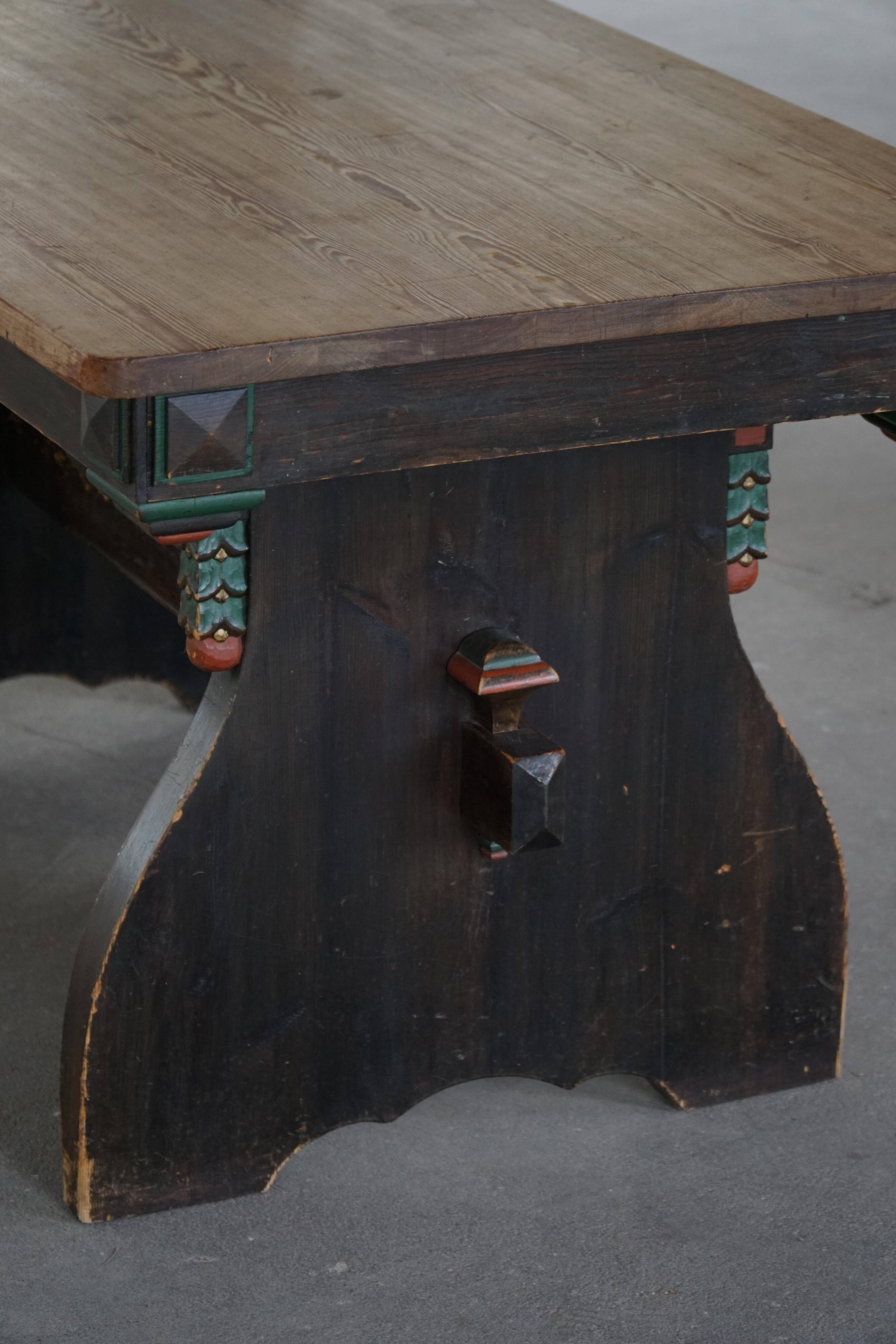 Rustic Scandinavian dining table in stained pine, Sweden, 1900-1940.