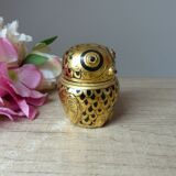 Old small black and gold lacquered wooden box in the shape of an owl