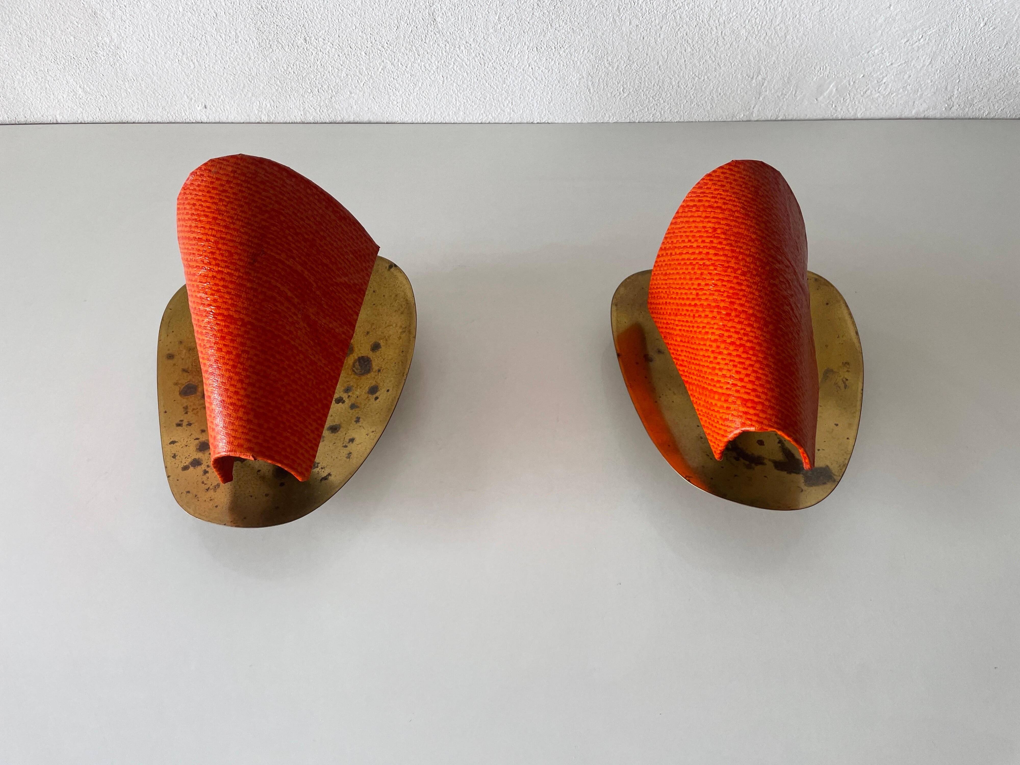Pair of orange plexiglass and curved brass wall lights, 1950s, Germany