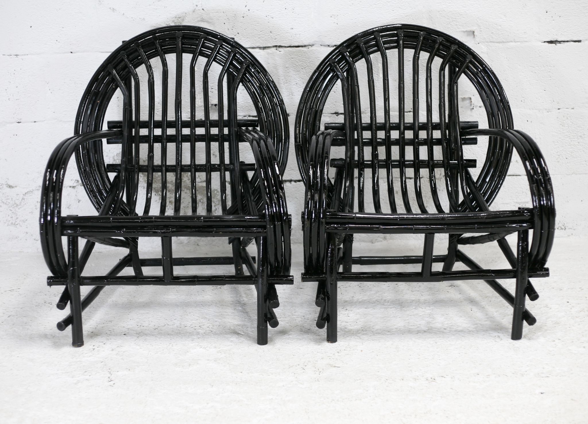 Pair of black lacquered rattan armchairs. France, cira 1960.