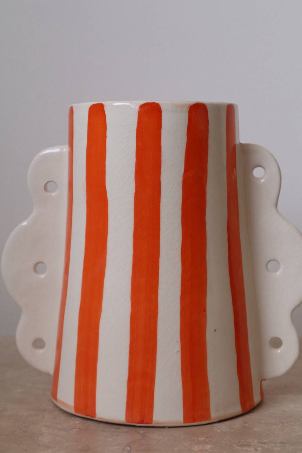 Orange and white striped ceramic abstract vase