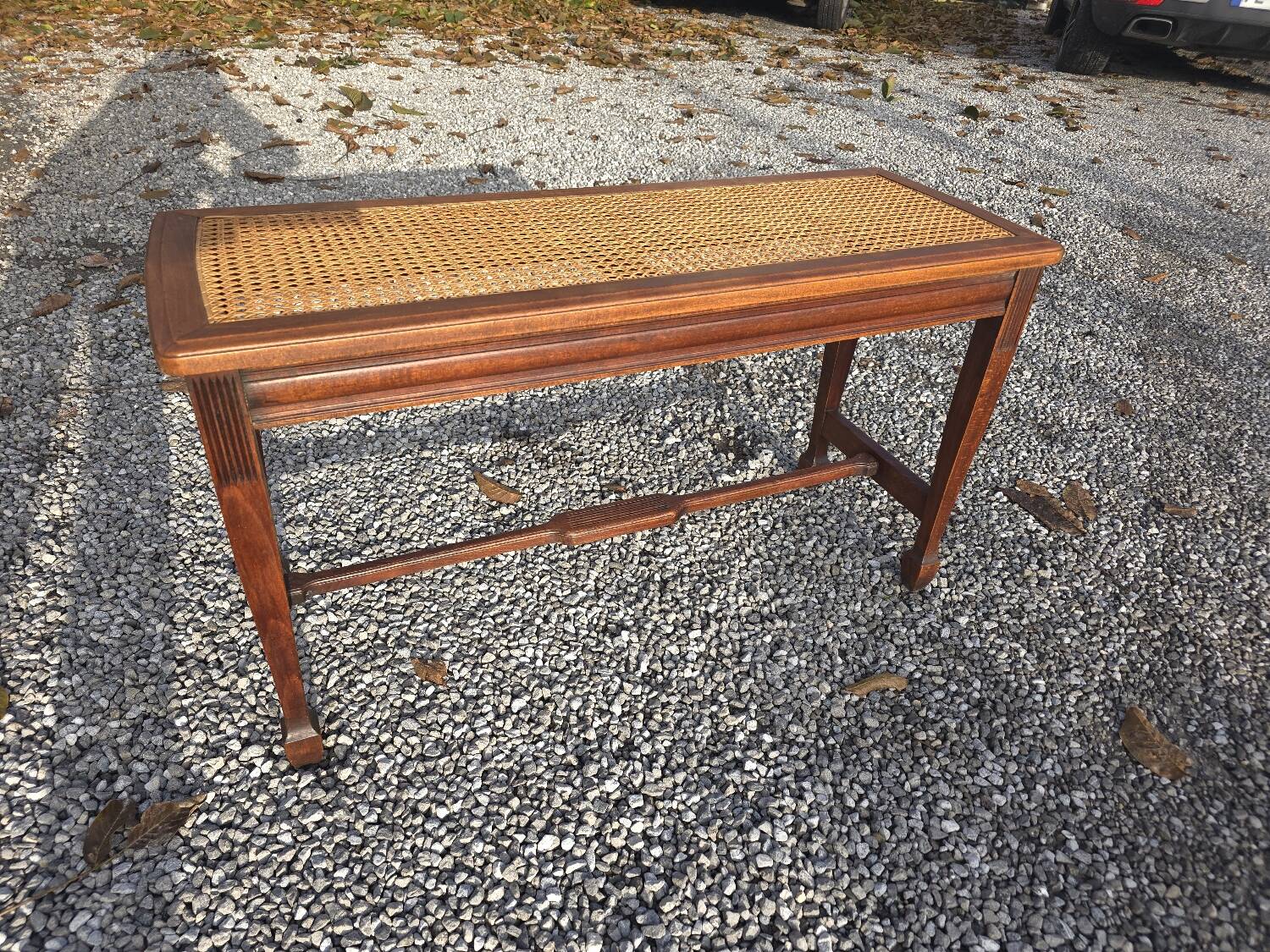 Beechwood piano bench with caning on the seat
