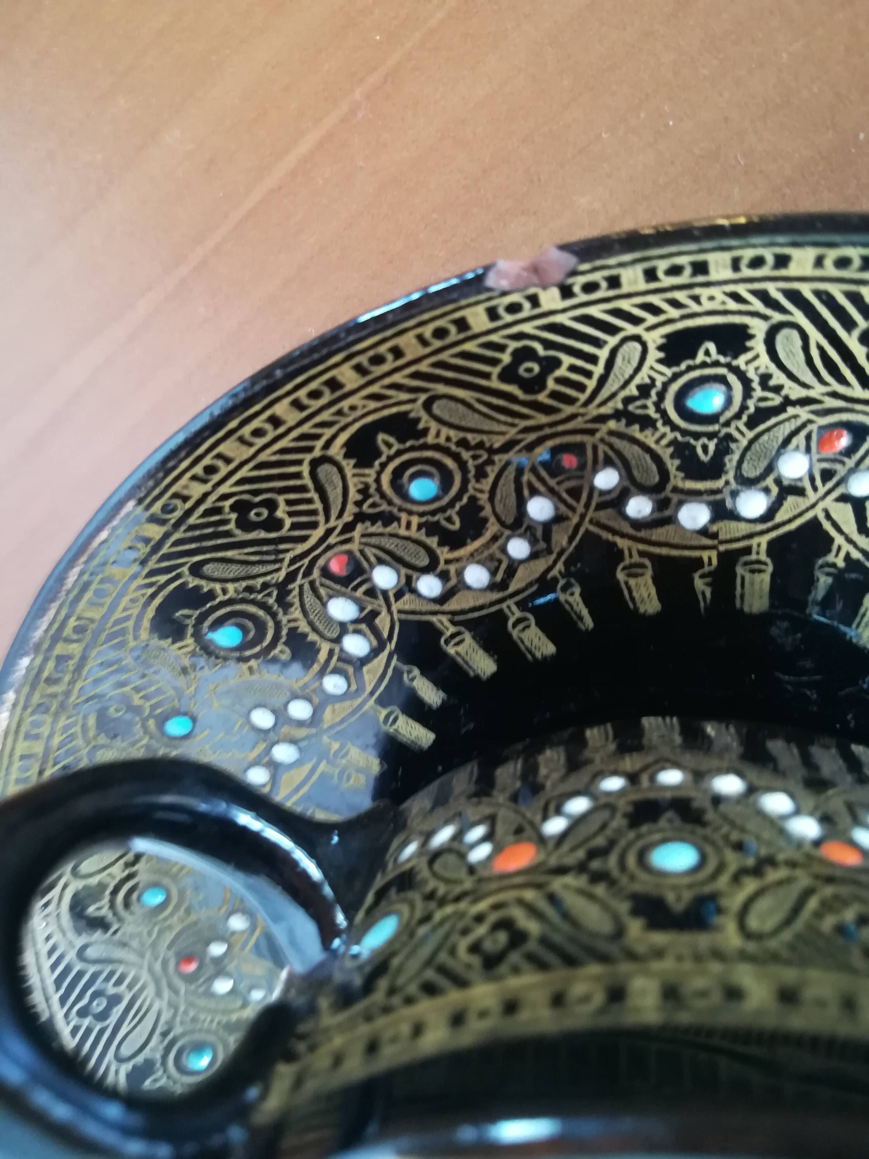 Black cups and saucers with relief decoration