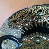 Black cups and saucers with relief decoration