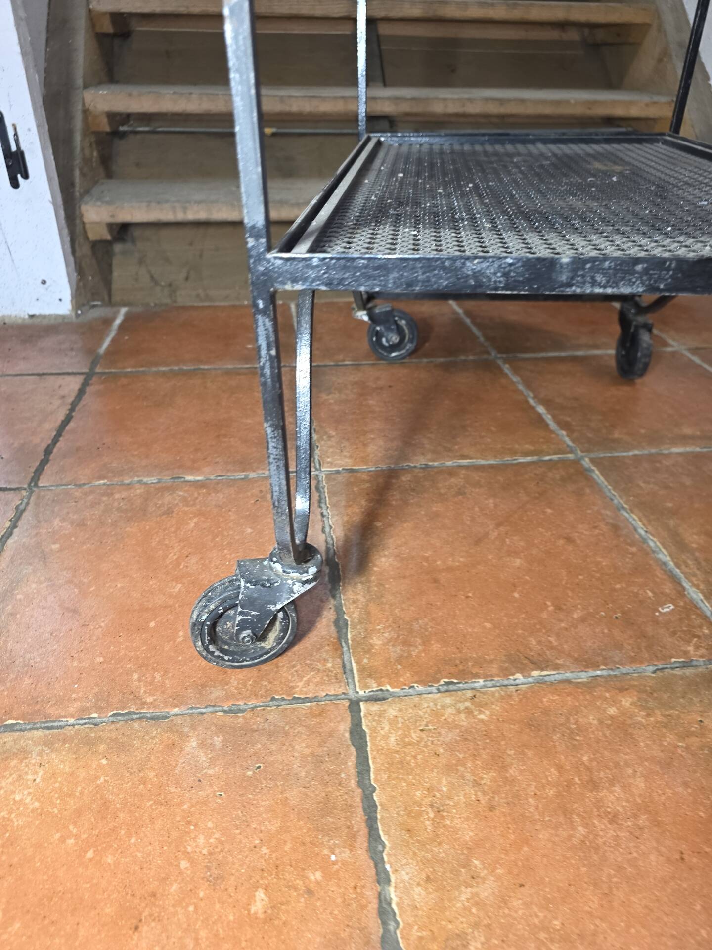 Perforated wrought iron rolling dessert trolley