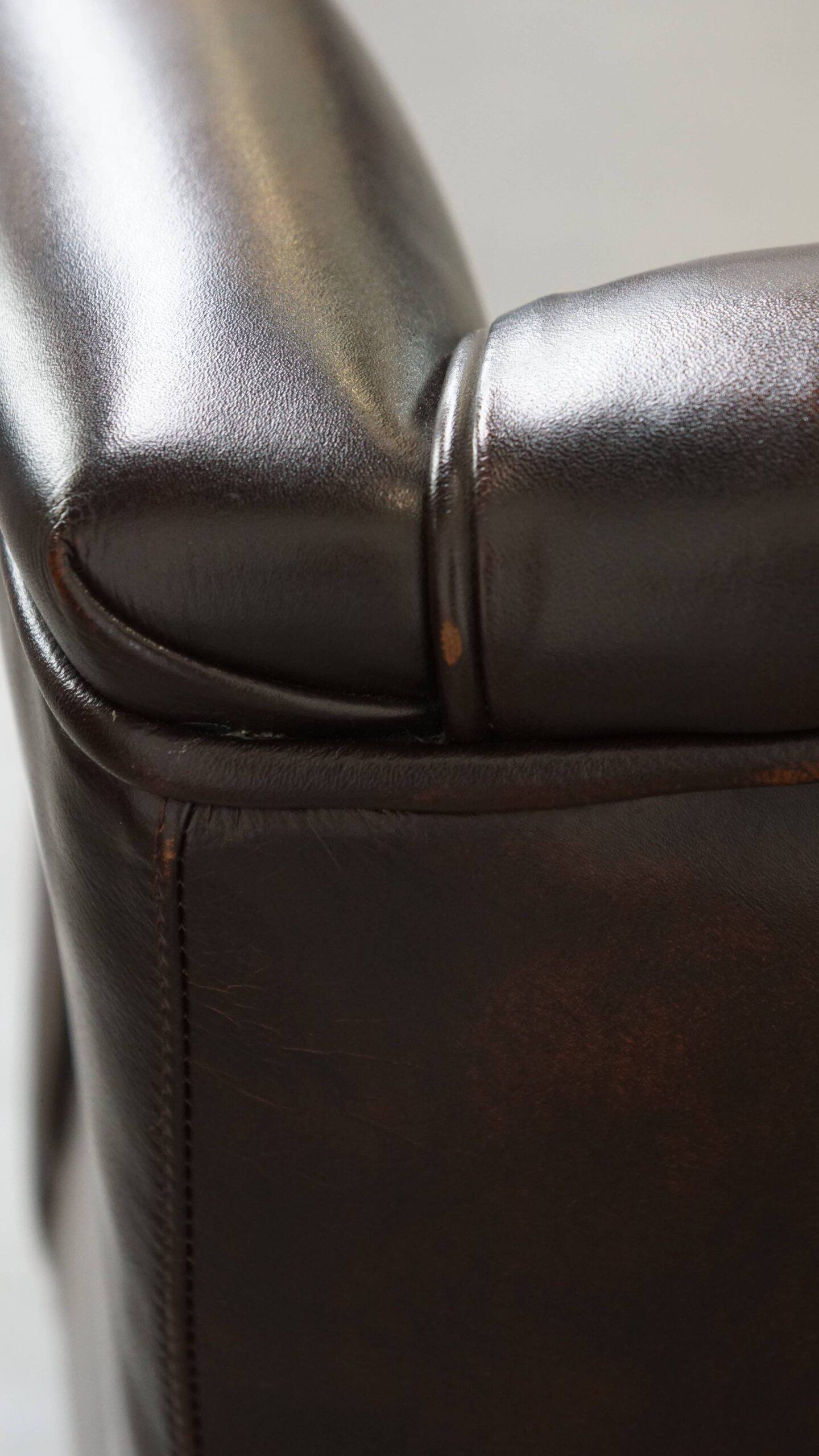 Comfortable wingback chair in English style made of cowhide leather