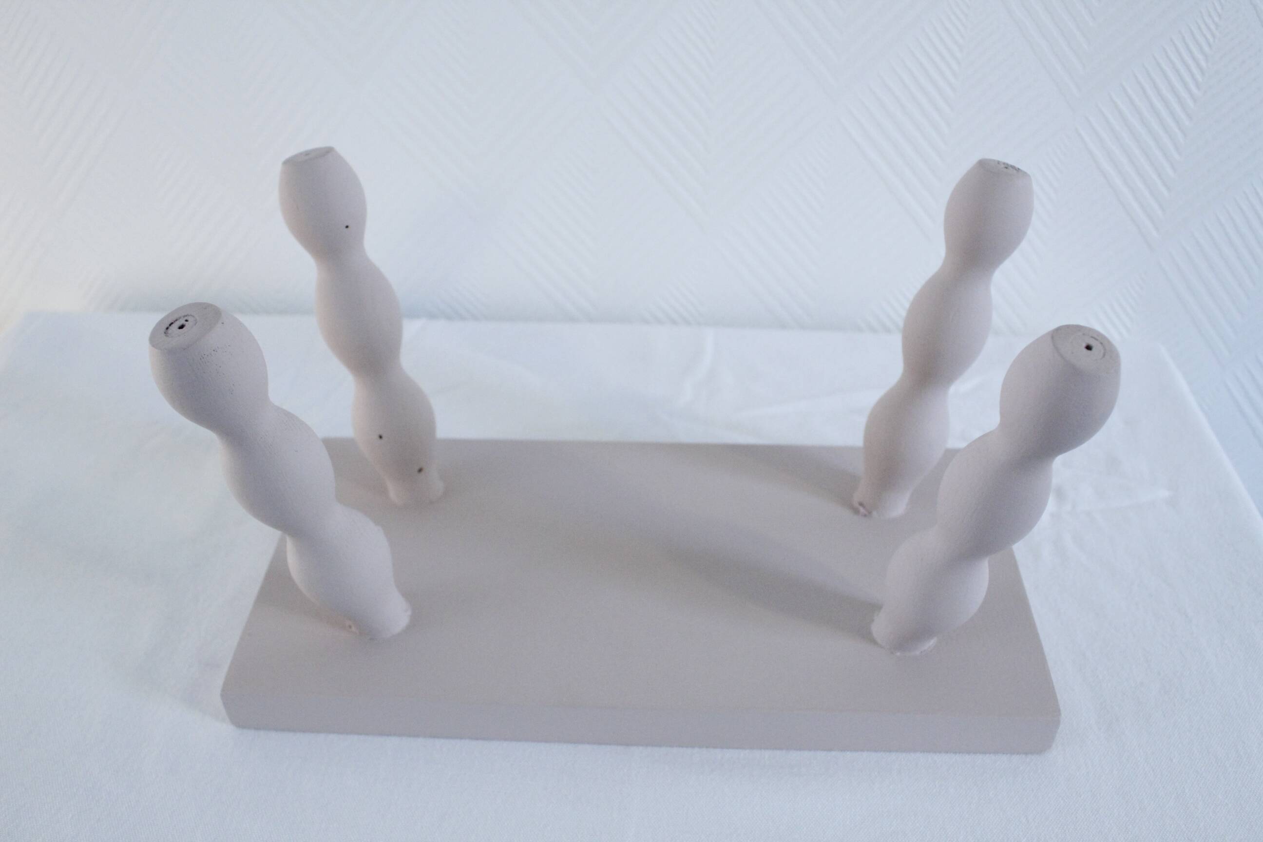 Small vintage wooden bench renovated in pinkish beige