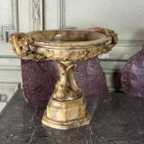 Alabaster bowl decorated with vine leaves on a base of three dolphins, circa 1880.