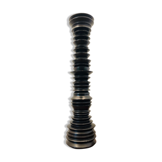 A brutalist black pepper mill